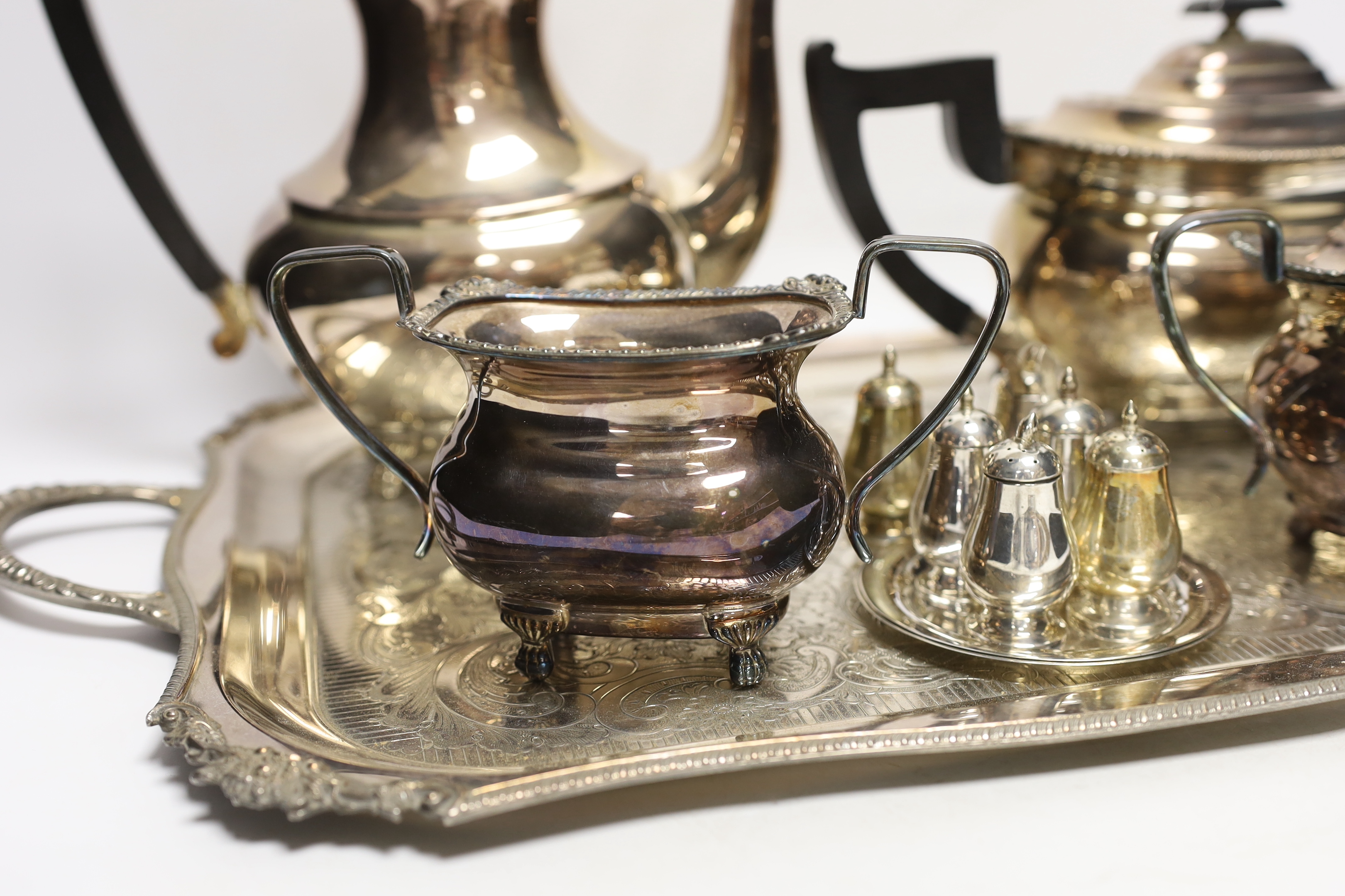 A plated tea / coffee set with ebonised handles and two Sterling condiment sets